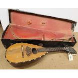 A vintage cased mandolin with eight strings (signs of age and use)
