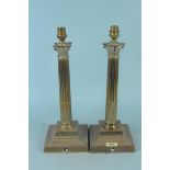 A pair of brass column table lamps,