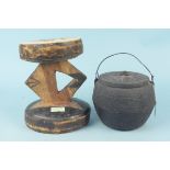A carved wooden ethnic stool plus an Oriental cast iron cooking pot