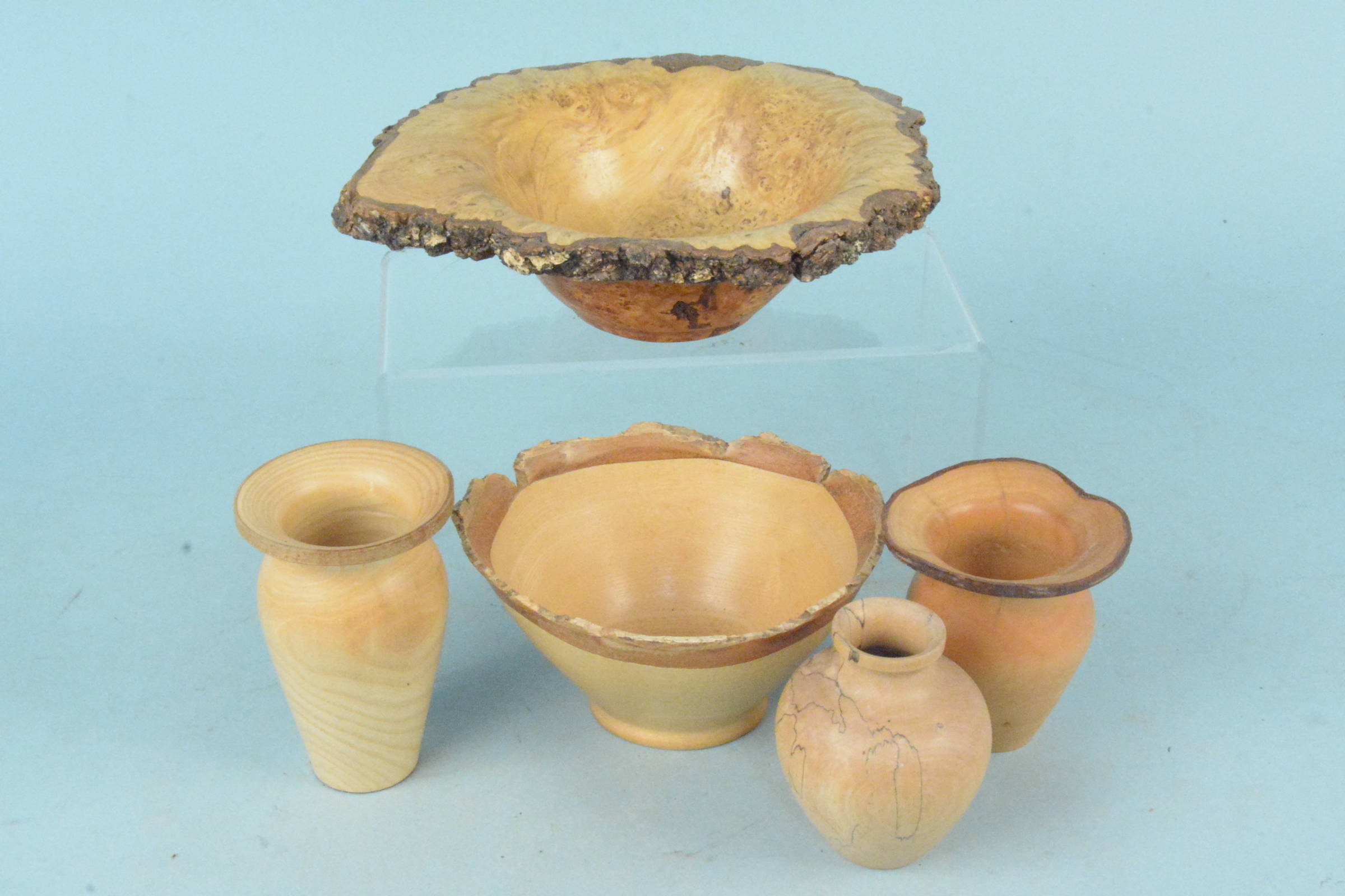 Five turned wooden bowls and vases