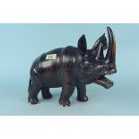 A carved ebony model of an African rhino,