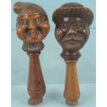 Two 19th Century continental wooden nut crackers with carved caricature faces and thread handles