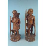 A pair of carved wooden Peruvian style male and female figures,