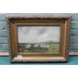 A gilt framed oil on canvas of sheep grazing in a field,