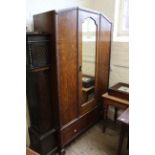 A 1930's oak wardrobe with shallow carved mouldings