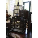 A rustic wirework and wooden framed bird cage