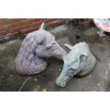 Two large horse head garden ornaments