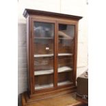 A late Victorian oak two door glazed wall cabinet