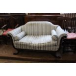 A late 19th Century mahogany scroll end settee on swept feet with carved paw feet, approx.