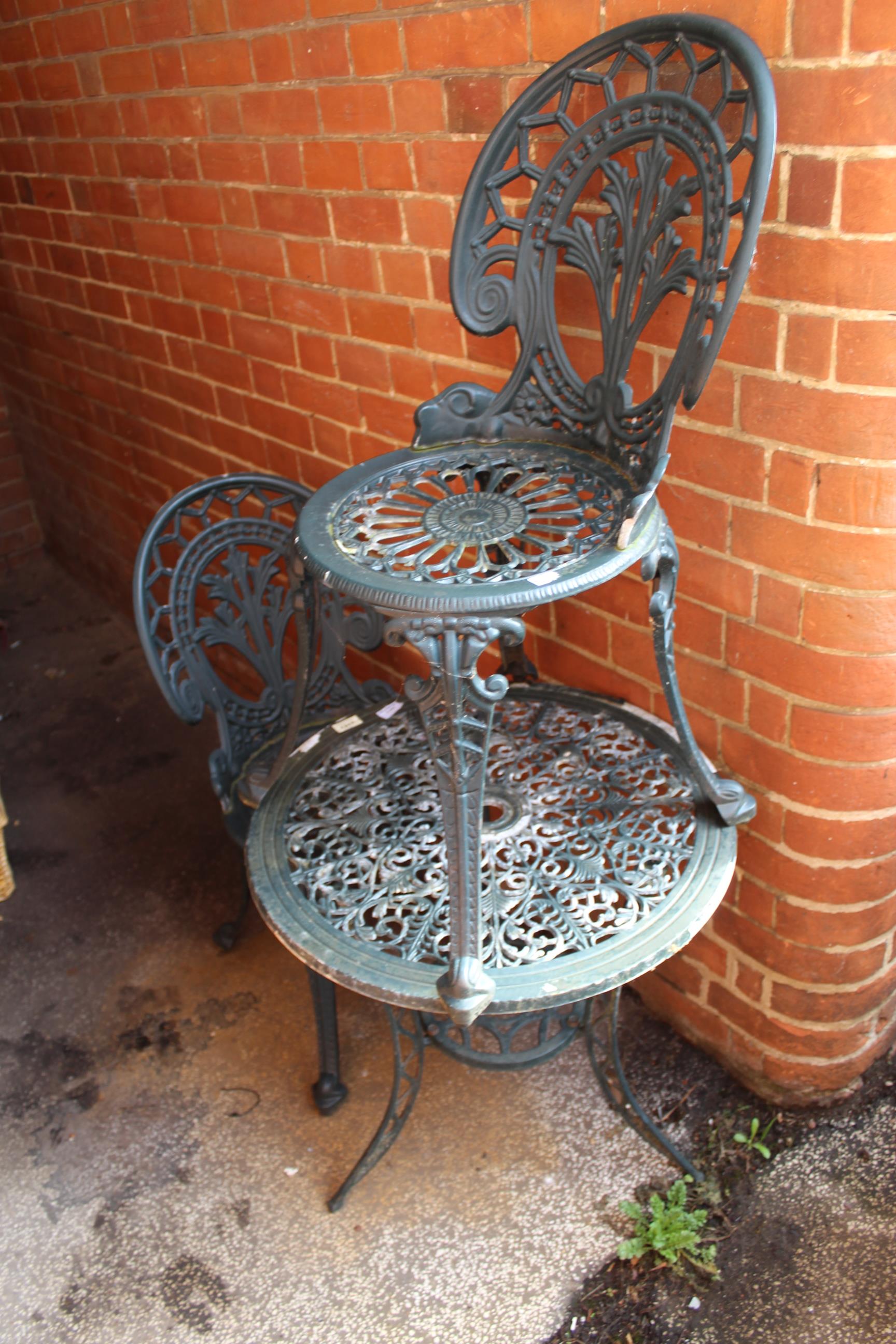A metal garden table and two chairs