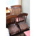 A late Victorian slatback kitchen armchair and a pair of slatback single chairs
