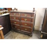 An early 18th Century oak four drawer chest with applied mouldings and panelled sides