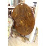 A Victorian inlaid walnut oval top table on cabriole legs