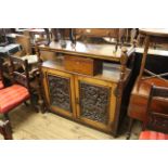 A late Victorian carved oak two door buffet