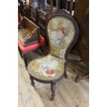 A Victorian carved walnut lady's chair with original beadwork covering
