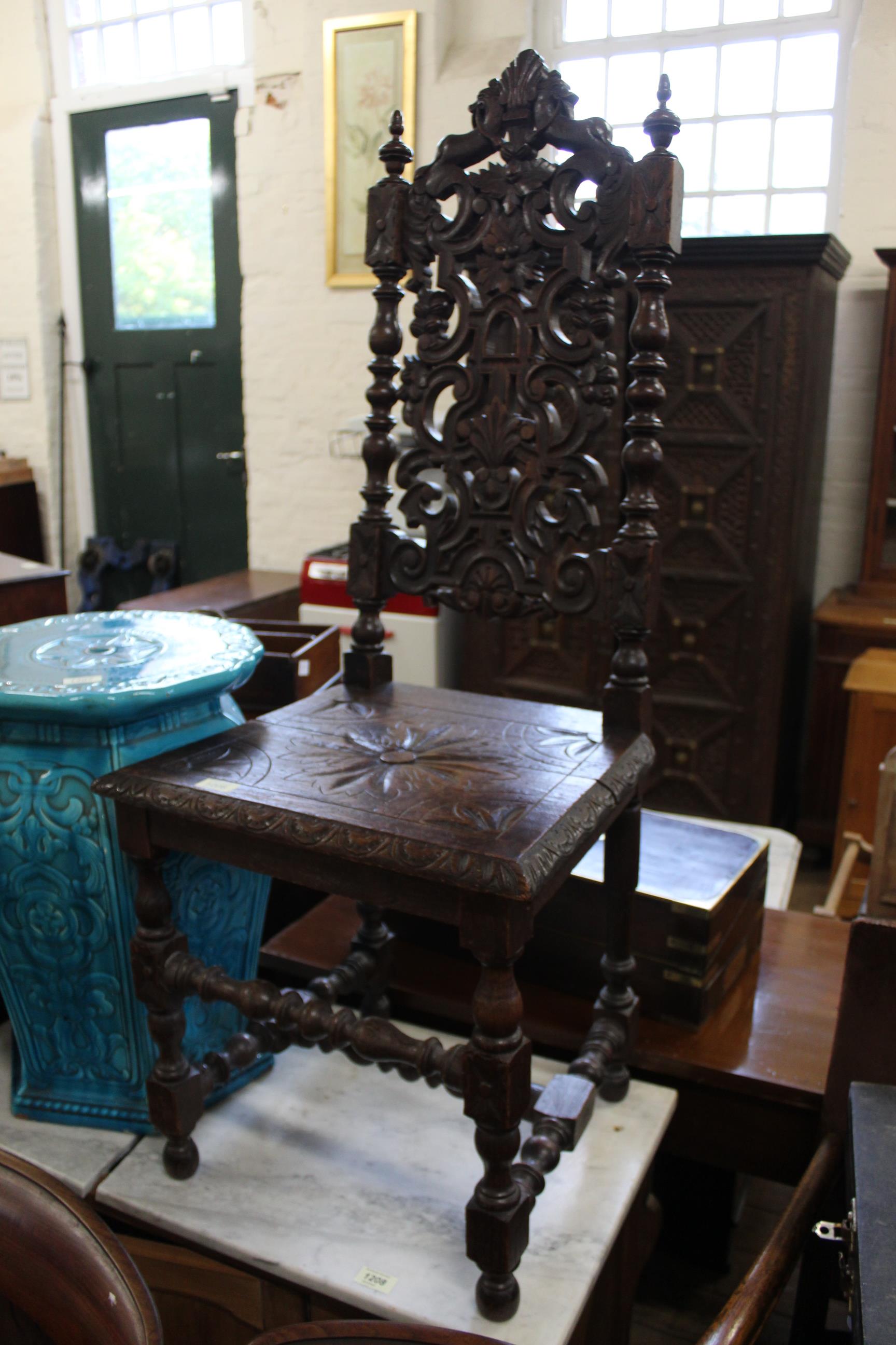 A late Victorian carved oak hall chair