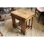 A nest of three oak coffee tables