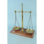 A set of late 19th Century brass shop scales by Pike & Elliman on mahogany base