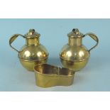 A pair of 19th Century brass lidded milk jugs stamped 'Pint' plus a miniature brass hip bath