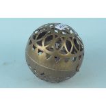 A brass circular pierced brass carriage hand warmer with hinged lid and gimbled spirit burner