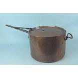 A large heavy 19th Century seamed copper saucepan having copper and iron handles with a lid having
