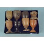 A selection of eight late 19th Century turned wooden egg cups, various woods including mahogany,