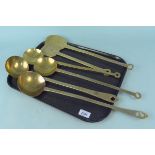 Four 19th Century brass ladles plus two brass skimmers