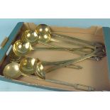 Eight assorted brass ladles