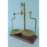 A brass set of late 19th Century shop scales by Avery Ltd on mahogany base