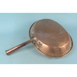 A large 19th Century oval copper frying pan with tubular copper handle,