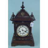 A Junghans German large wooden cased mantel clock with enamel face and brass ornamentation,