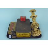 A pair of gilded candlesticks together with three collectors advertising tins and a vintage cast