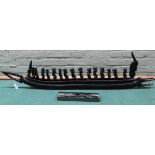 A large vintage (possibly Congolese) carved wooden crocodile war canoe with fifteen rowers,