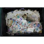 A large tub of mixed loose stamps