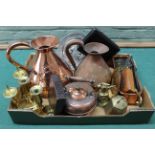 A large seamed copper jug together with one other plus candlesticks,