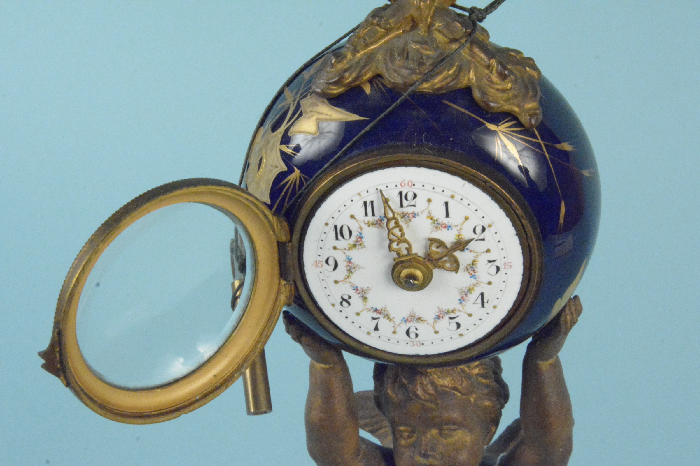 A 19th Century French gilded metal cherub supporting a ceramic clock, - Image 3 of 3