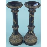 A pair of heavy contemporary cylindrical wood pricket candlesticks painted with dragons and having