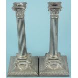 A pair of Elkington & Co silver plated candlesticks in the Neo Classical style,