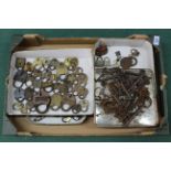Four small boxes of mixed antique small padlocks,