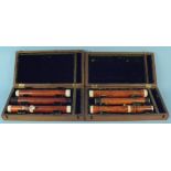 Two turned wooden flutes in fitted cases,