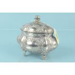 A continental 830 grade bulbous form silver casket on four paw feet with embossed floral decoration