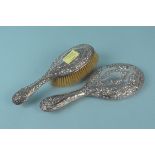 A silver backed hand mirror and brush