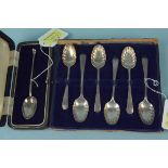 A cased set of six silver teaspoons with shaped bowls and floral engraved handles together with a
