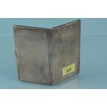 A silver cigarette case with engine turned decoration and engraved monogram to front and