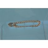 A 9ct gold bracelet with 9ct gold heart shaped padlock clasp, weight approx 14.