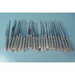 Twenty four silver handled knives with bead pattern (sixteen side and eight table),