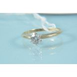 An unmarked yellow metal solitaire diamond set ring, size N,