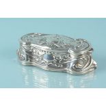 An Art Nouveau silver trinket pot with embossed floral swag and bird decoration,