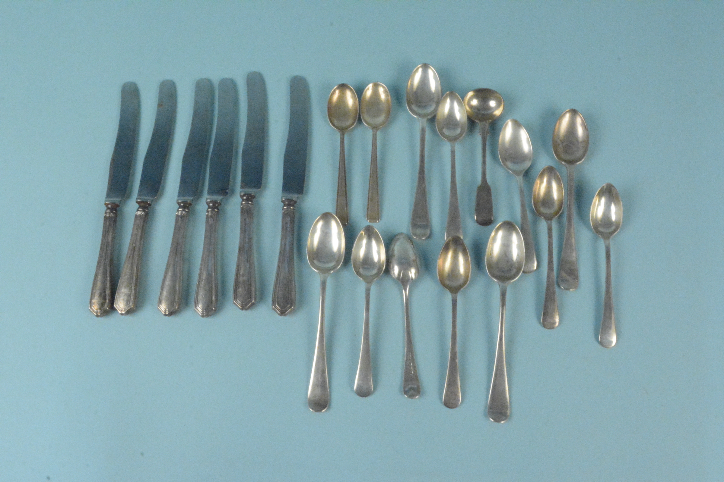 Mixed silver cutlery consisting of various teaspoons, a cruet spoon and six silver handled knives,