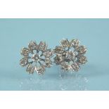 A pair of 9ct white gold diamond set floral design earrings,